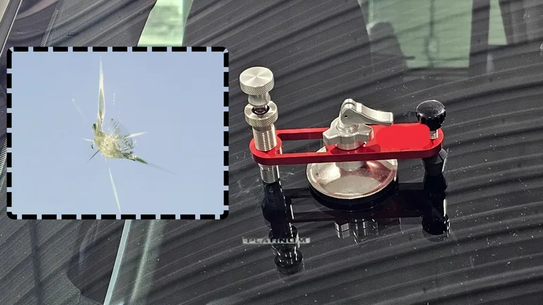 Windshield chip repair tool positioned over damaged glass