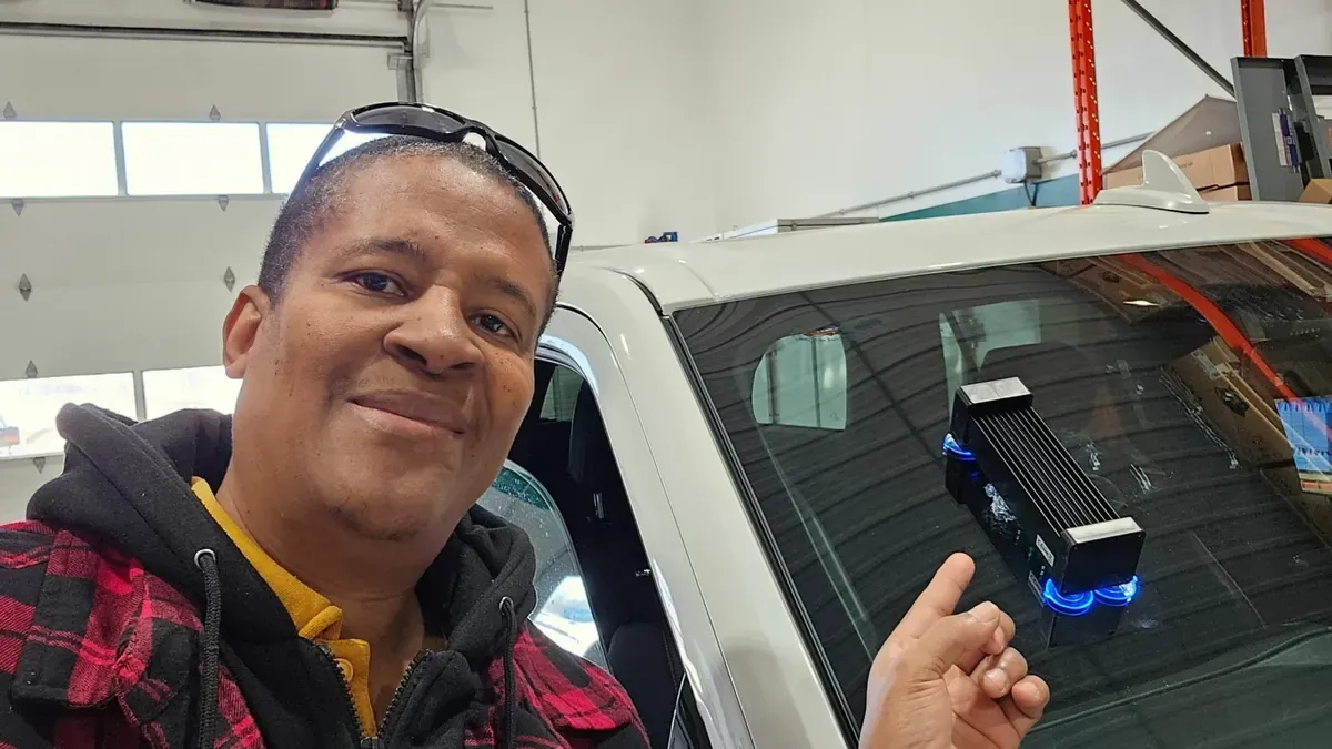 Technician assessing windshield stone chip damage from inside the vehicle